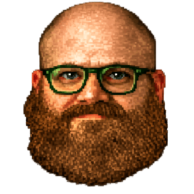 Scott Benson — bald, auburn beard, green glasses